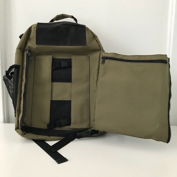 Green backpack with opened flap to show place to put skateboard.