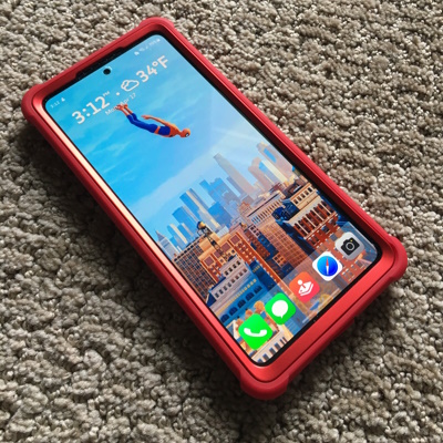 red cell phone front showing spiderman falling on the screen.
