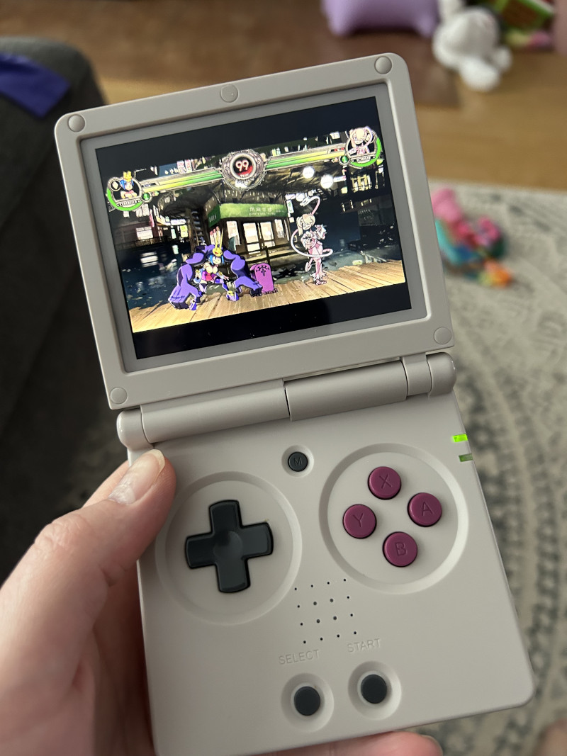 hand holding gameboy sp